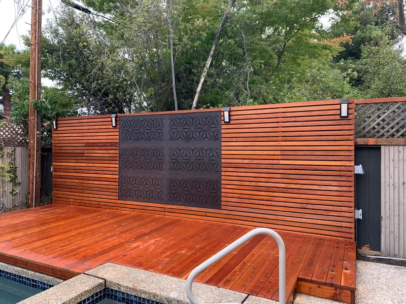 Outdoor wall-mounted lights on cedar privacy fence by pool deck — East Bay Electrical